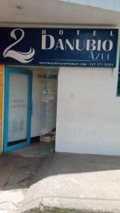 a store with a blue sign on the side of a building at Hotel Danubio Azul in Yopal