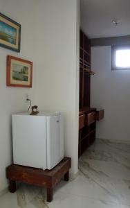 a small white refrigerator in a room at Pousada Samambaia in Paraty