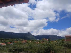 a view of a village with mountains in the background at Casa Cinza Marichi Hospedagem in Vale do Capao
