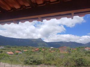 a view of a town with mountains in the background at Casa Cinza Marichi Hospedagem in Vale do Capao