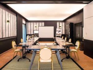 a conference room with a long table and chairs at Mercure Carcassonne La Cité in Carcassonne +94 photos