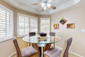 a dining room with a glass table and chairs at Evening Star in Indian Wells