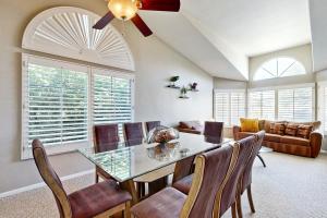 a dining room with a glass table and chairs at Evening Star in Indian Wells