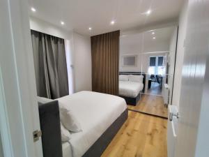 a bedroom with a bed and a living room at Best in Class - London, Harrow in Harrow