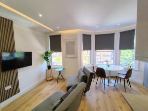 a living room with a couch and a table at Best in Class - London, Harrow in Harrow