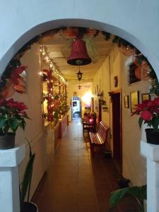 an archway in a hallway with christmas decorations at Hotel Casa de Oriente in San Bartolo
