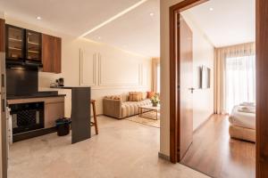 a kitchen and a living room with a couch at Résidence Luxoria - Gauthier in Casablanca