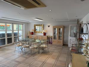 a dining room with a glass table and chairs at Villa avec piscine à Super Cannes in Vallauris