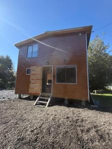 a tiny house sitting on top of a pile of gravel at Tiny House A & M Chaiten in Chaitén