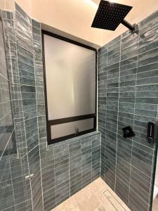 a shower with a large screen in a bathroom at Suite privada en hotel Boutique in Bogotá +8 photos