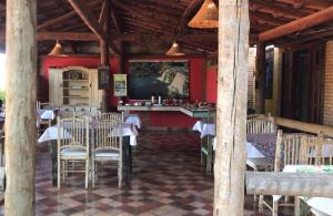 a dining room with tables and chairs in a restaurant at Pousada Beira Rio Cipó in Serra do Cipo