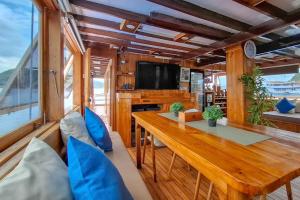 a dining room with a wooden table and chairs at Private Trip Labuan Bajo 2D1N in Labuan Bajo