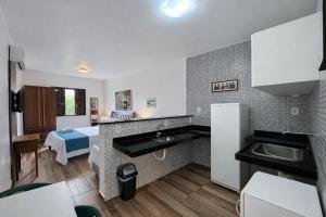 a kitchen with a sink and a counter top at FLAT Estalagem 11 in Arraial do Cabo
