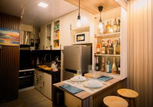 a kitchen with a counter with plates and glasses on it at G-Luxe Panabo Guesthouse - Unit A in Panabo +2 photos