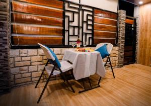 a dining room with a table and two chairs at G-Luxe Panabo Guesthouse - Unit A in Panabo