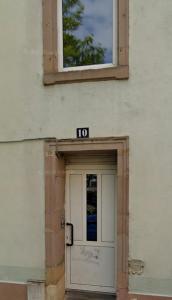 a building with a door with a sign above it at Ocean 300m Gare Centre ville Wifi Parking gratuit in Belfort