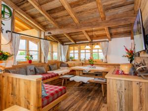a living room with wooden floors and wooden ceilings at Das Rendlgut Top 4 in Lofer