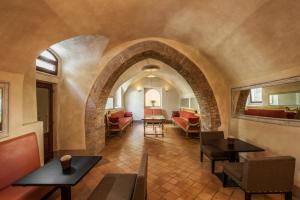 an archway in a room with tables and chairs at San Biagio Relais in Orbetello