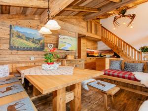 a dining room with a table and a couch at Das Rendlgut Top 4 in Lofer