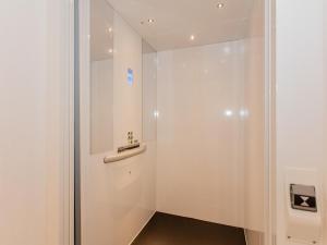a bathroom with a white door with a sink at Das Rendlgut Top 4 in Lofer +8 photos