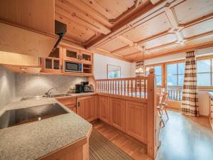 a kitchen with wooden cabinets and a counter top at Andre Top 2 in Wald im Pinzgau