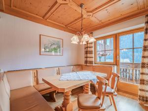 a dining room with a table and chairs at Andre Top 2 in Wald im Pinzgau +7 photos