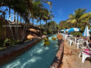 a lazy river at a resort with yellow rubber ducks at Spazzio diRoma com acesso ao Acqua Park in Caldas Novas