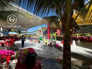 a group of people in the water at an amusement park at Spazzio diRoma com acesso ao Acqua Park in Caldas Novas