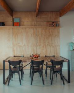 a dining room table with four chairs around it at The Rectory Zeehan in Zeehan