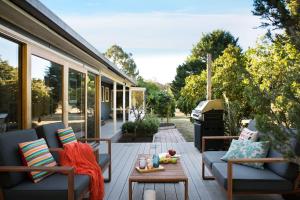 a patio with two couches and a coffee table at Langfields in Glenlyon +5 photos