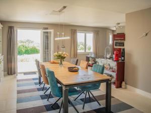 a kitchen and dining room with a wooden table and chairs at Les Graves in Saint-Pierre-Lafeuille