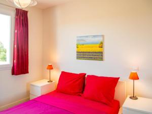 a bedroom with a bed with red pillows and a painting at Les Graves in Saint-Pierre-Lafeuille +33 photos