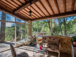 a screened in porch with a chair and a table at Orchidée in Barjols