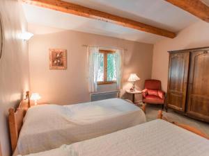 a bedroom with two beds and a chair and a window at Orchidée in Barjols +35 photos