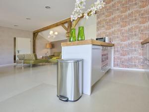 a kitchen and living room with a counter with bottles on it at Design Farmers Barn Twente in Haaksbergen