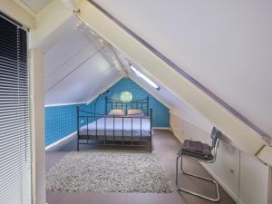 a bedroom with a bed in a attic at Design Lodge Twente in Haaksbergen