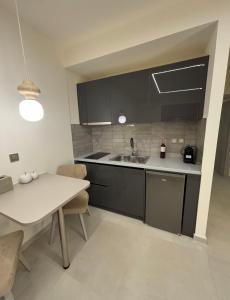 a kitchen with a white table and a sink at SAmalia Apartments Nafplio in Nafplio +121 photos