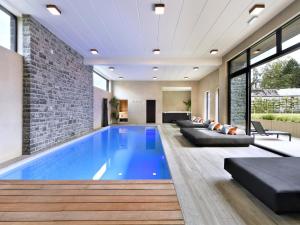 a swimming pool in a house at Villa with Pool & Suites for 12 Guests in Durbuy