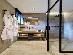 a bathroom with a tub and a sink and a shower at Villa with Pool & Suites for 12 Guests in Durbuy +31 photos