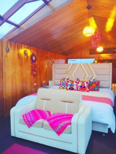 a bedroom with a large white bed with pink pillows at Titikaka sky view lodge in Puno