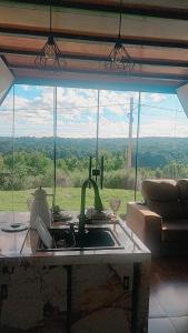 a kitchen with a sink and a view of a window at Chalé estrela de ouro in Alexânia