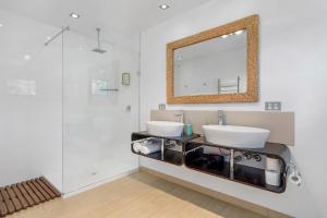 a bathroom with two sinks and a mirror at Bruny Island Escapes and Hotel Bruny in Alonnah +152 photos