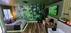 a bedroom with a bed and a large painting on the wall at Zen Retreat-Jacuzzi, kitchenette, Walk to fun in Reno