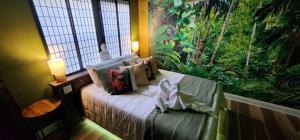 a bedroom with a bed with a large window at Zen Retreat-Jacuzzi, kitchenette, Walk to fun in Reno