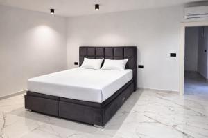 a bed with white sheets and pillows in a bedroom at Vila SOL DEL MAR in Utjeha +5 photos