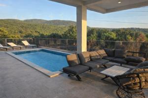 a patio with a couch and a swimming pool at Vila SOL DEL MAR in Utjeha
