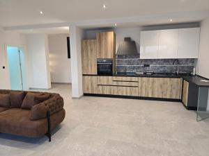 a living room with a couch and a kitchen at Vila SOL DEL MAR in Utjeha