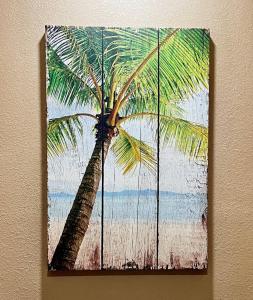 a painting of a palm tree on a wall at Tropical Spa Studio, Jacuzzi, Kitchen, Sparks in Sparks