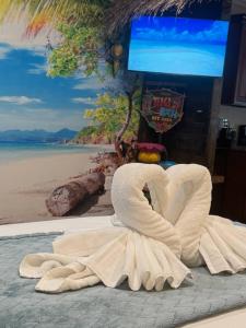 a towel shaped like a heart sitting on a beach at Tropical Spa Studio, Jacuzzi, Kitchen, Sparks in Sparks