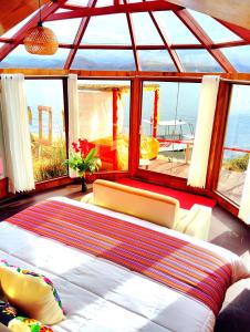a bedroom with a large bed and a large window at Titikaka sky view lodge in Puno +16 photos